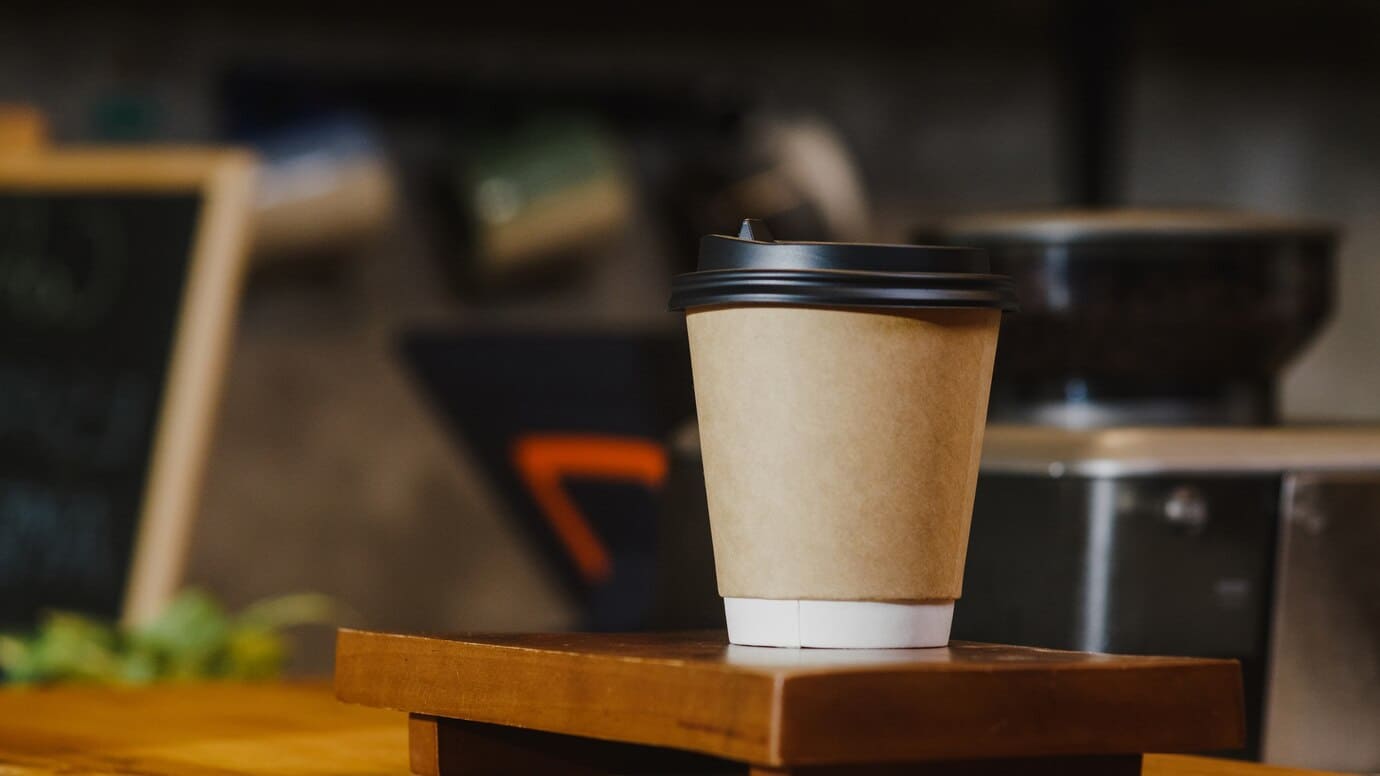 take-away-hot-coffee-paper-cup-consumer-standing-bar-counter-cafe-restaurant_7861-3247 (1).jpg