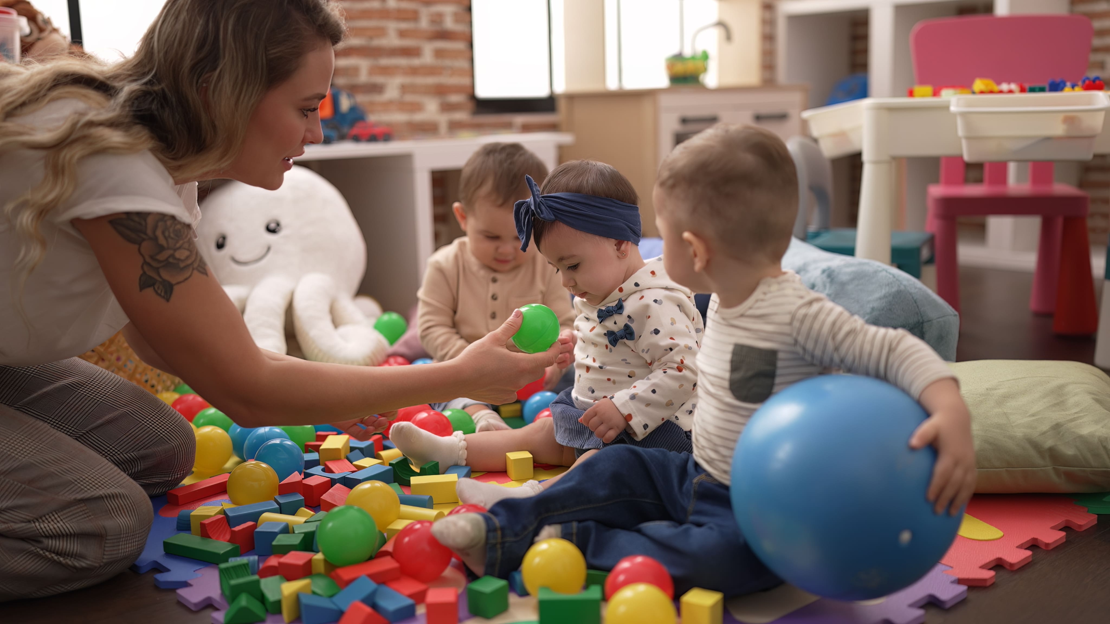 teacher-preschool-students-playing-with-balls-sitting-floor-kindergarten (1).jpg teacher-preschool-students-playing-with-balls-sitting-floor-kindergarten (1).jpg